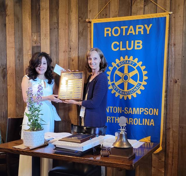 Outgoing Rotary President Eileen Coite, right, presents member Georgina Zeng with the Rotarian of the Year award, the clubs highest honor.
                                 Sherry Matthews|Sampson Independent