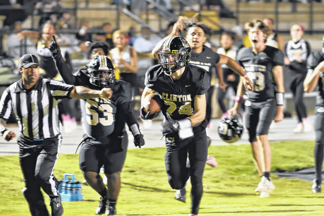 130981515_web1_D4S_6171
Will Mercer, #24, heads to the end zone with a pick-six as the Clinton sideline erupts in celebration.
Mike Carter|Sampson Independent