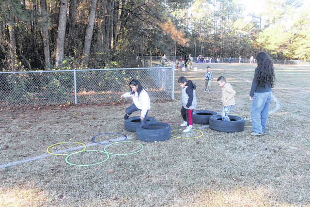 Kindergarten students quickly dash through the tire run at Union Elementary Monday.
                                 Photos by Noah Britt | Sampson Independent