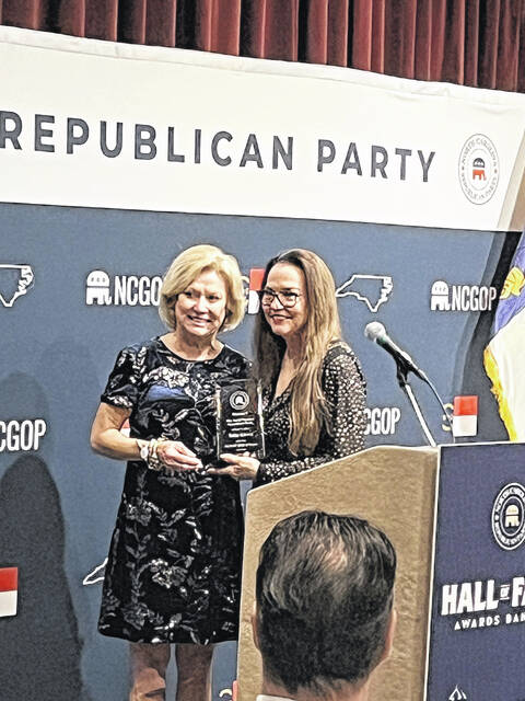 Former Sampson County Republican chairwoman Telia Kivett was inducted into the state GOP Hall of Fame Saturday, Nov. 8, an honor and a surprise, she said. According to a program about the Hall of Fame, organizers and Party officials noted that each nominee and inductee has demonstrated exceptional commitment to the GOP cause  going above and beyond in their service to the Party and their communities. Their steadfast support of the NCGOP and their work behind the scenes have laid the foundation for our Partys continued growth and success. Simply put, the victories weve achieved and the victories yet to come would not be possible without their energy, dedication and service. Kivett, current chairwoman of the GOP 7th Congressional District, has held numerous positions in the GOP ranks, including assistant secretary and secretary to NCGOP State Convention, elector for the Trump inauguration, delegate to the last three national conventions, delegate to the last eight NC conventions and chairwoman of the Sampson Republican Party for eight years. This is her second term as leader of the 7th Distrist. Pictured presenting Kivett the Hall of Fame honor is Susan Mills, past vice chairwoman of the NCGOP and current NCGOP secretary. Also pictured with Kivett is her husband, former Sampson County Commissioners Chairman Jerol Kivett.