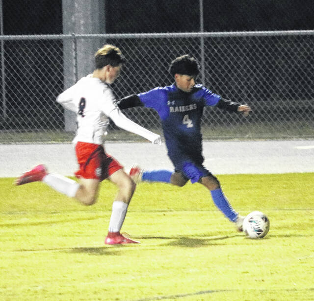 Raider Jeffrey Flores works the sideline on a drive toward the goal Monday night.