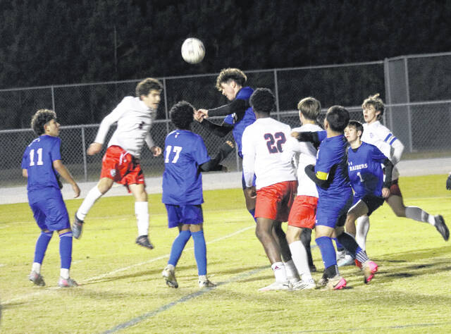 A pack of Raiders ward off a corner kick in the second half as a header clears the ball out.