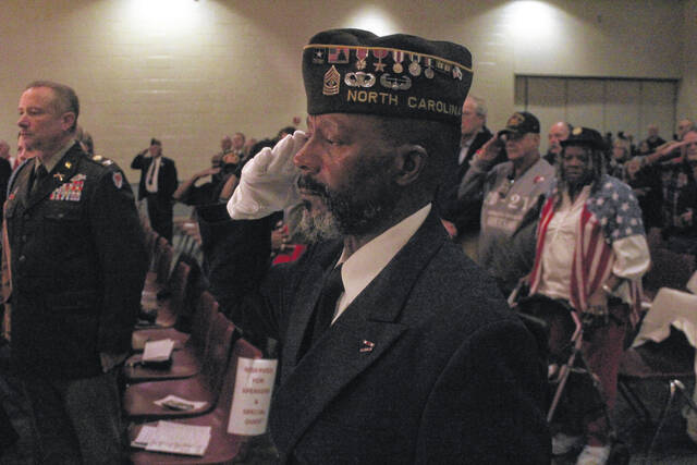 Members of the Color Guard Post #7547 salute the flag as the colors are posted.
                                 Noah Britt | Sampson Independent