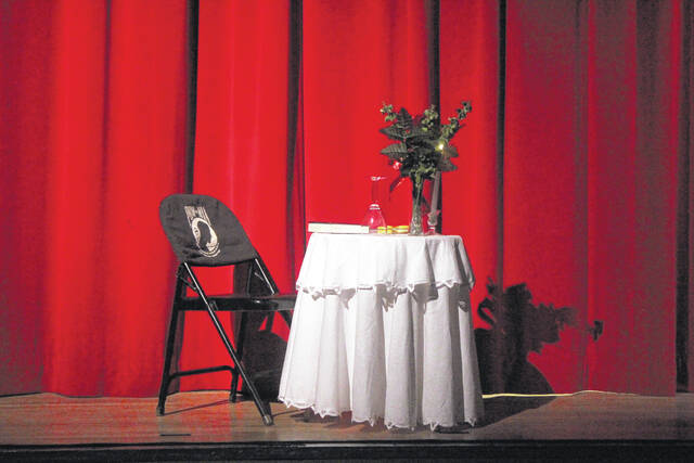 To honor prisoners of war and those missing in action, an empty seat at a table is placed onstage.
                                 Noah Britt | Sampson Independent