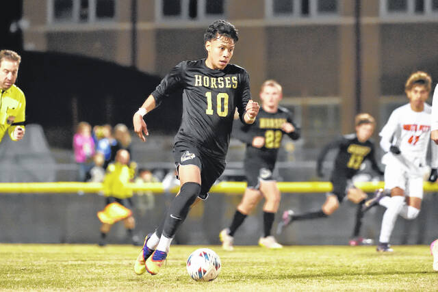 Clintons Chris Zelaya driving the ball through midfield, putting the Dark Horses in scoring position.