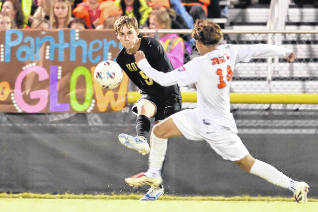 Dark Horse senior, Cullen Brewer, fires the ball past a defending Panther.