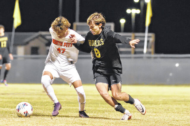 Dark Horse defender, Mason Stewart, battles with a Panther in an attempt to gain possession of the ball.