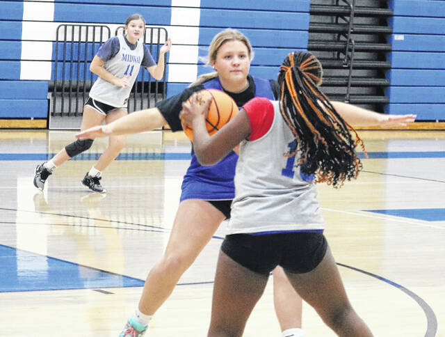 Ella Clark spreads her arms wide while working on her defensive stance during a Lady Raiders practice.