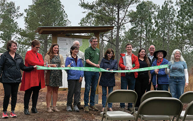 Roseboro-area officials and representatives for the Mountains-to-Sea Trail cut the ribbon to open the portion of the trail at Pondberry Bay Preserve.
Trevon McGlone| Sampson Independent