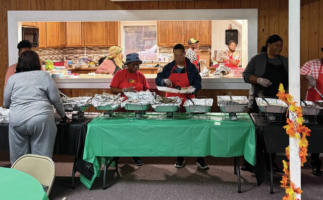 Volunteers serve plates at Garlands community Thanksgiving event on Tuesday.
Trevon McGlone| Sampson Independent