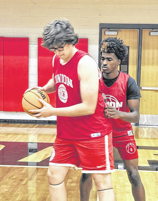 Senior leader Manny Adams, right, is working with the incoming big man Julian Edwards to show him some different post moves to use against defensive positions.