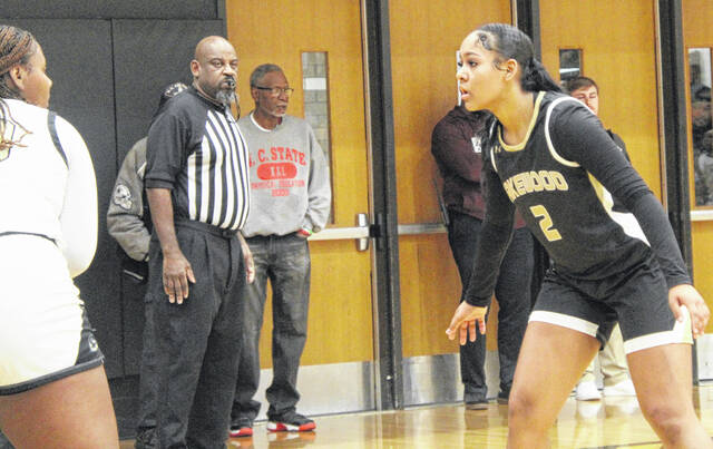 Lakewood sophomore Takiyah Carr breaks down in her defensive stance to prevent a baseline pass.
