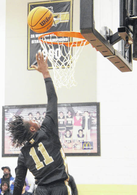Lakewoods Travon Carr finishes at the rim as the Leopards surge back after an early deficit Friday.