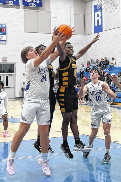 Midway big Harry Johnson snags a rebound against Wildcat senior Reggie Thompson and Amir Tate.