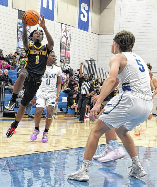 Hobbton junior guard Amir Tate adds two points to the score as he slides through Midways defense Friday.