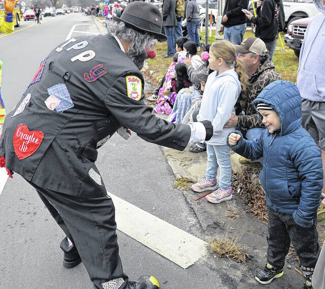 It might have been cold and a bit misty Saturday throughout Sampson County, but it didnt stop Newton Grove from kicking off Christmas in grand style with its annual parade, which drew a bundled up crowd to the circle and parts of the downtown to watch the colorful floats sweep through town. Pictured, a Dunn Clown gives a youngster a fist bump while the Grinch steals a fist bump; the Hobbton High Band plays some holiday music for the crowd; the Sudan Street Racers delight parade-goers and, of course, Santa makes his appearance as the parade closes out.
