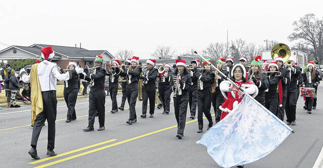 It might have been cold and a bit misty Saturday throughout Sampson County, but it didnt stop Newton Grove from kicking off Christmas in grand style with its annual parade, which drew a bundled up crowd to the circle and parts of the downtown to watch the colorful floats sweep through town. Pictured, a Dunn Clown gives a youngster a fist bump while the Grinch steals a fist bump; the Hobbton High Band plays some holiday music for the crowd; the Sudan Street Racers delight parade-goers and, of course, Santa makes his appearance as the parade closes out.