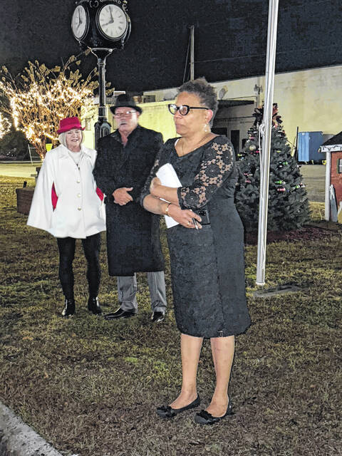 Mayor Pro Tem Carolyn Melvin, alongside Garland Mayor Ralph Smith Jr. and his wife, Rhonda, greet those who braved the drizzle and cold Saturday to attend the towns tree lighting.