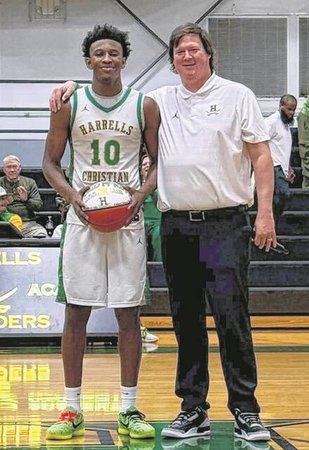 Antonio McKoy with head coach Clayton Hall during Fridays game, acknowledging his accomplishment.