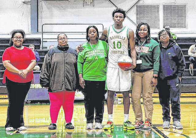 Antonio McKoy seen alongside some of his family. McKoy stated he will give one commemorative ball to his mom, and one to his grandmother.