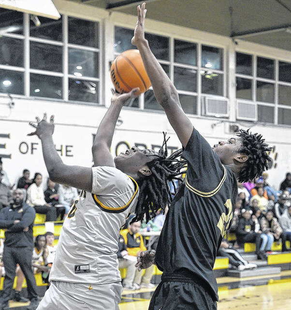 Wildcat Javarus Johnson finishes hard at the rim as his team attempts to chip away at Clintons lead.