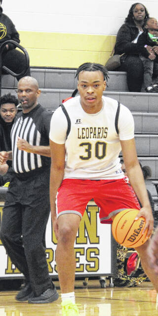 Class of 24 Lakewood grad Shamell Little sizes up before he makes his move to the basket.