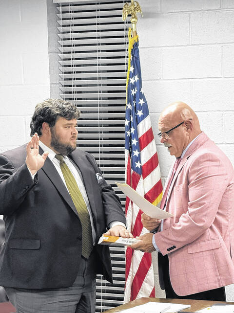 New member of the planning board Brandon Smith is sworn in by Mayor Ralph Smith Jr. Trevon McGlone| Sampson Independent