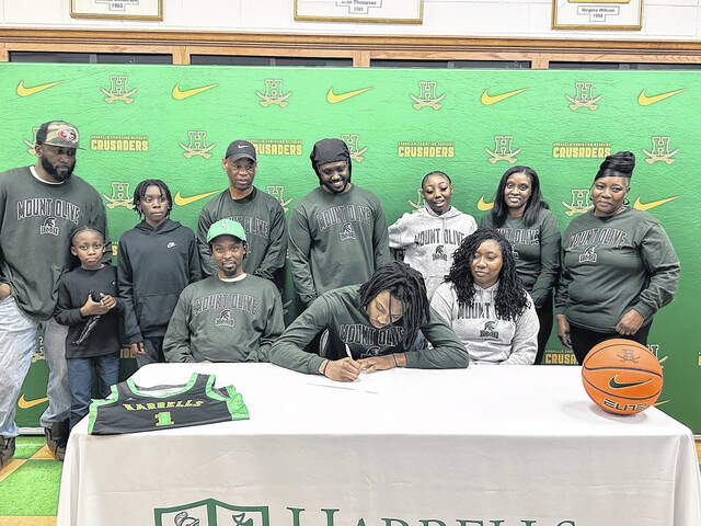 Dashaun McKoy, surrounded by family, signs his letter of intent to UMO on Wednesday afternoon.