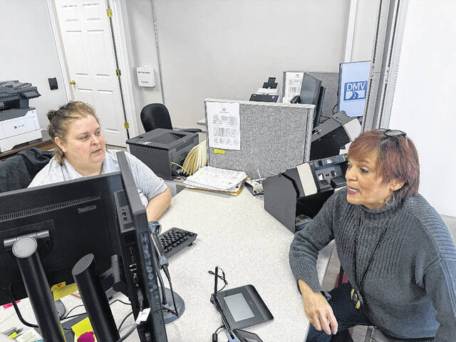 Garland DMV employee April Singletary listens as customer Carolyn Parker asks for information regarding travel with her ID.
                                 Trevon McGlone| Sampson Independent