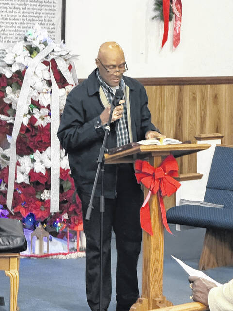 Deacon James Royal reads a Bible passage  Isaiah 40:27-31  during the scripture portion of the night.
                                 Trevon McGlone| Sampson Independent