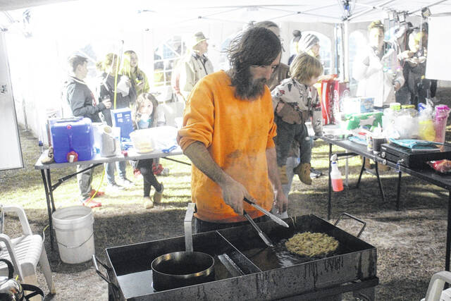 Steven Smith with HRK Concessions fries up funnel cakes for event spectators Wednesday during the Heart Drop event.
                                 Photos by Noah Britt | Sampson Independent