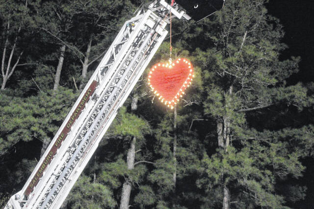 At the events start, the heart is lifted high among the trees by a fire truck crane