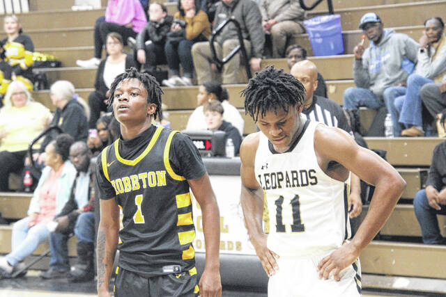 Hobbtons Amir Tate and Lakewoods Travon Carr gather their breath during a free throw after battling to the very end.