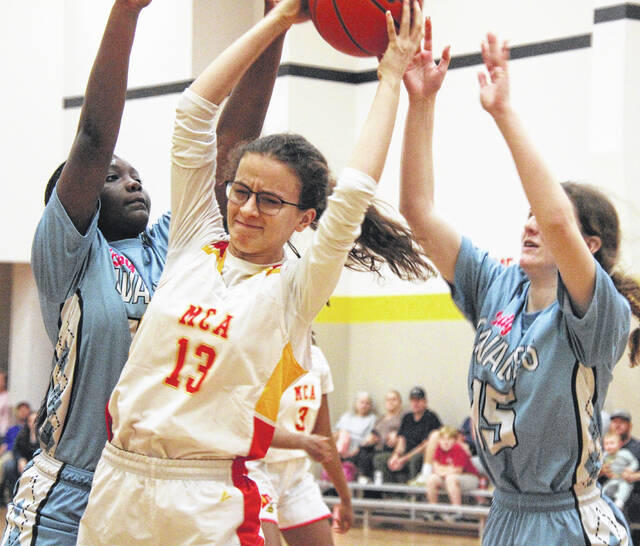 Mintz junior Mariana Naylor is trapped by Lady Cavaliers as they try to prevent a score.