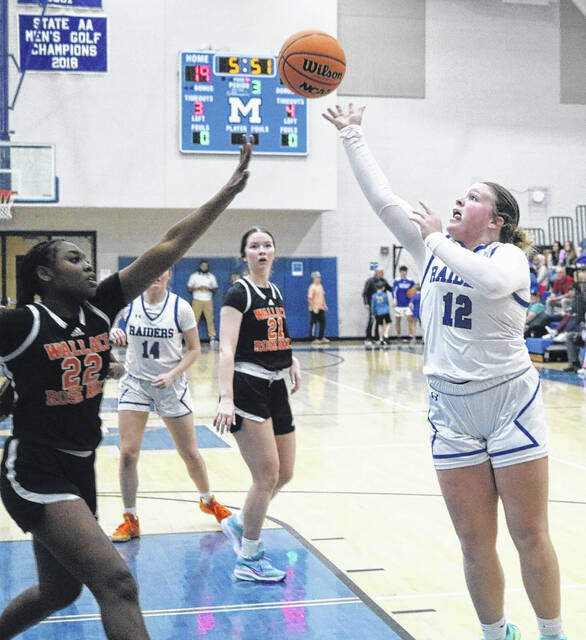 Lady Raider Ella Clark challenges WRHs defense, launching a shot over the top.