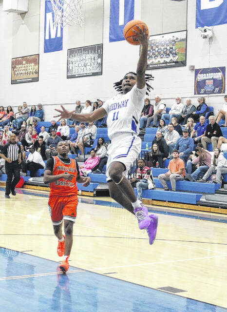 Junior Raider Colin Woods drives the lane in the second half and lays up two of his 31 points.