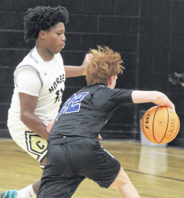 Clintons Messiah Bell tries to stay in front of Raider ball-handler Sam Scott, as he attempts to drive past.