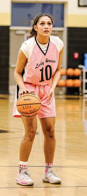 Lady Dark Horse Ruby Davila gathers herself at the line to help propel her team in the lead.