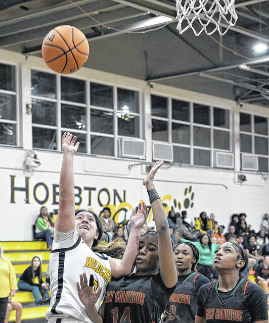 Lady Wildcat Valorie Bartolo finishes in the paint despite enduring contact.