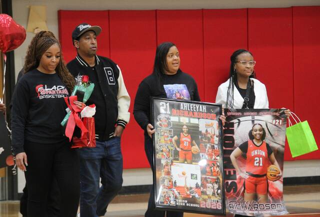 Senior Lady Spartan Ahleeyah Richardson being escorted by her family during Senior Night.