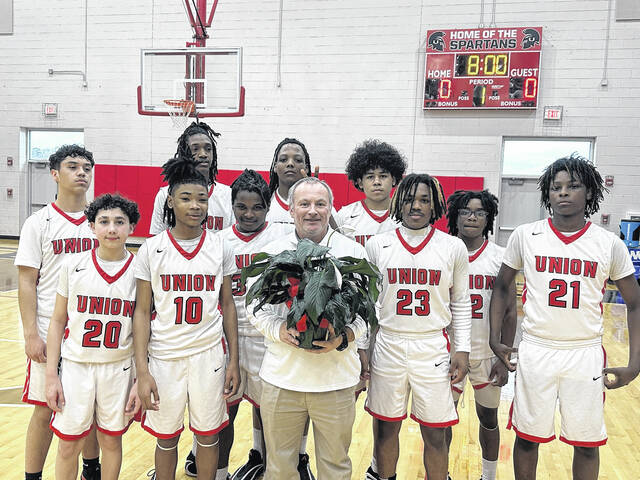 JV head coach Bryant Register was given his flowers by his team in recognition of his absence due to family matters. Register said the gesture was special.