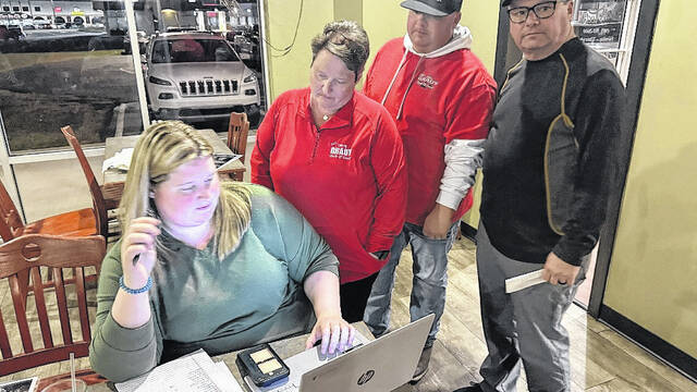 Tammy Grady watches vote totals roll on a computer run by daughter McKenzie Grady, as supporters look on during her watch party at Teds Steakhouse Tuesday night. Grady took 51 percent of the vote, becoming Sampsons first female Clerk of Court. (Trevon McGlone|Sampson Independent)