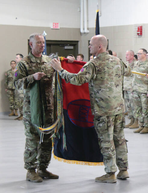 As part of the ceremony, Col. Wynn unveiled a new flag for the Armory, designating the transition from the 30th Armored Brigade Combat Team to the 30th Mobile Brigade Combat Team.
                                 Photos by Abby Cavenaugh | Sampson Independent