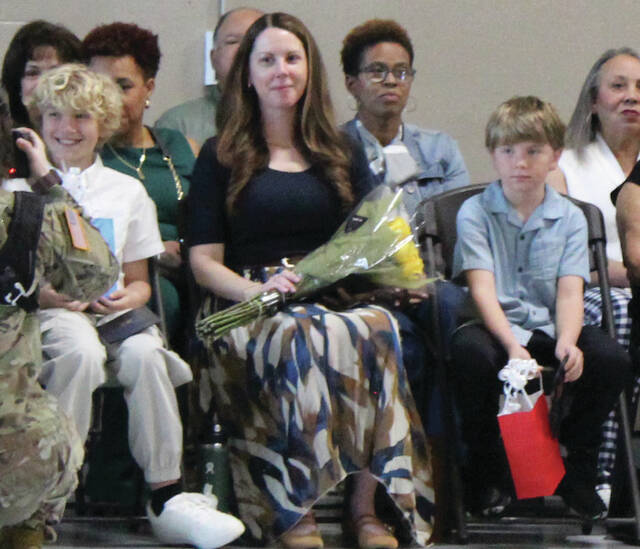 Marie Wynn, wife of incoming commander, Col. Ben Wynn, sits surrounded by her children and Col. Wynns stepsons, Henry and Brady. Photos by Abby Cavenaugh | Sampson Independent