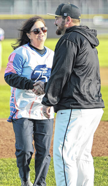 Sampson County Schools executive director Dr. Wendy Cabral meets with Clinton head coach Matthew DeLeone after throwing the first pitch of the game.