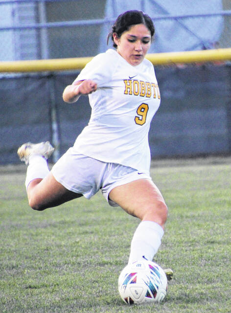 Junior Lady Wildcat Brenda Reyes clears the ball on a free kick.