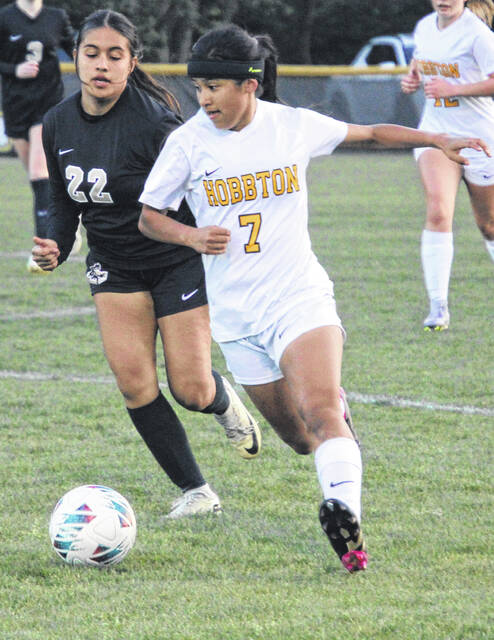 Hobbton captain Denisse Jorge-Garcia advances to scoring position while being closely guarded by Lady Dark Horse freshman Andrea Ortez.