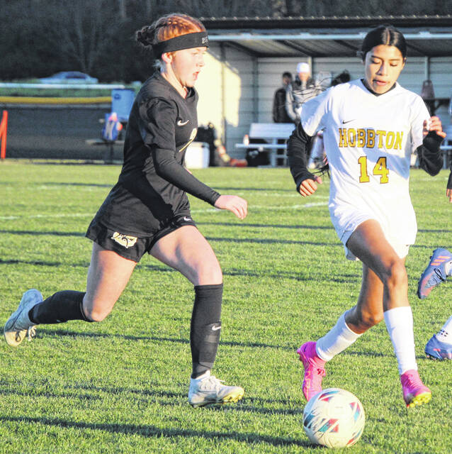 Clinton freshman Katie Hales battles to drive past Lady Wildcat Aaliyah Garcia.
