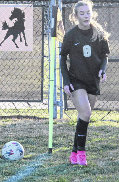 Lady Dark Horse Jenna Jackson, who had five goals on the night, prepares for a corner kick.