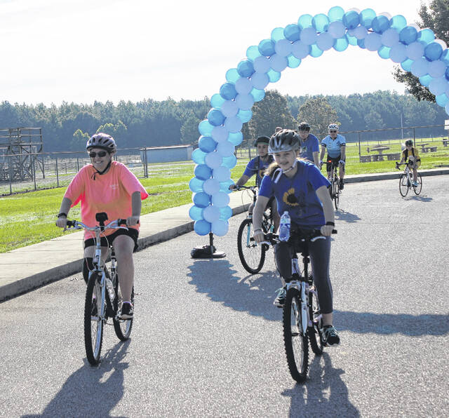 Cyclists cross the finish line at the first Tour De Sunflower bike ride in 2019.
                                 File photo